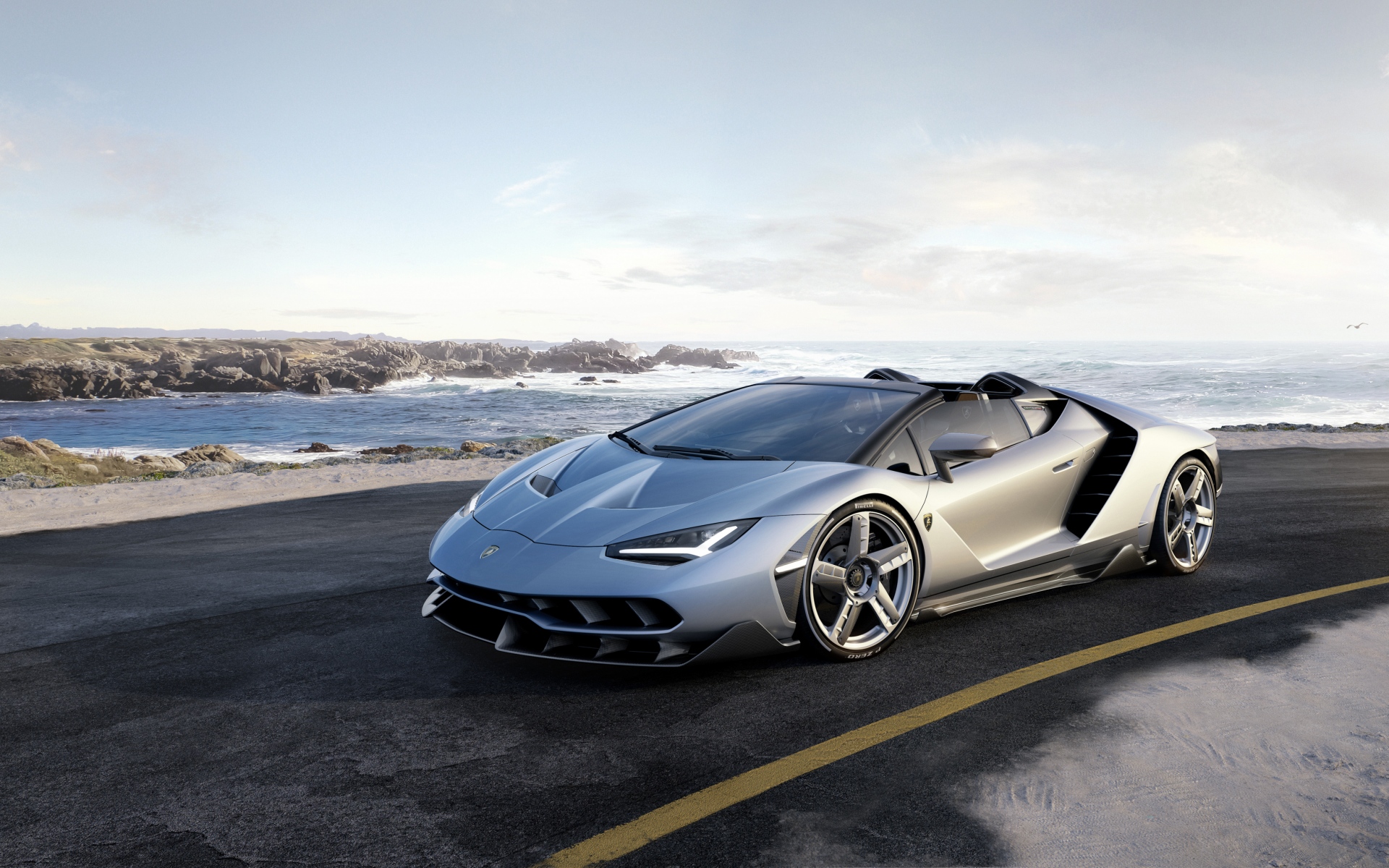 Картинки Lamborghini, родстер, дорога, море, камни фото и обои на рабочий стол
