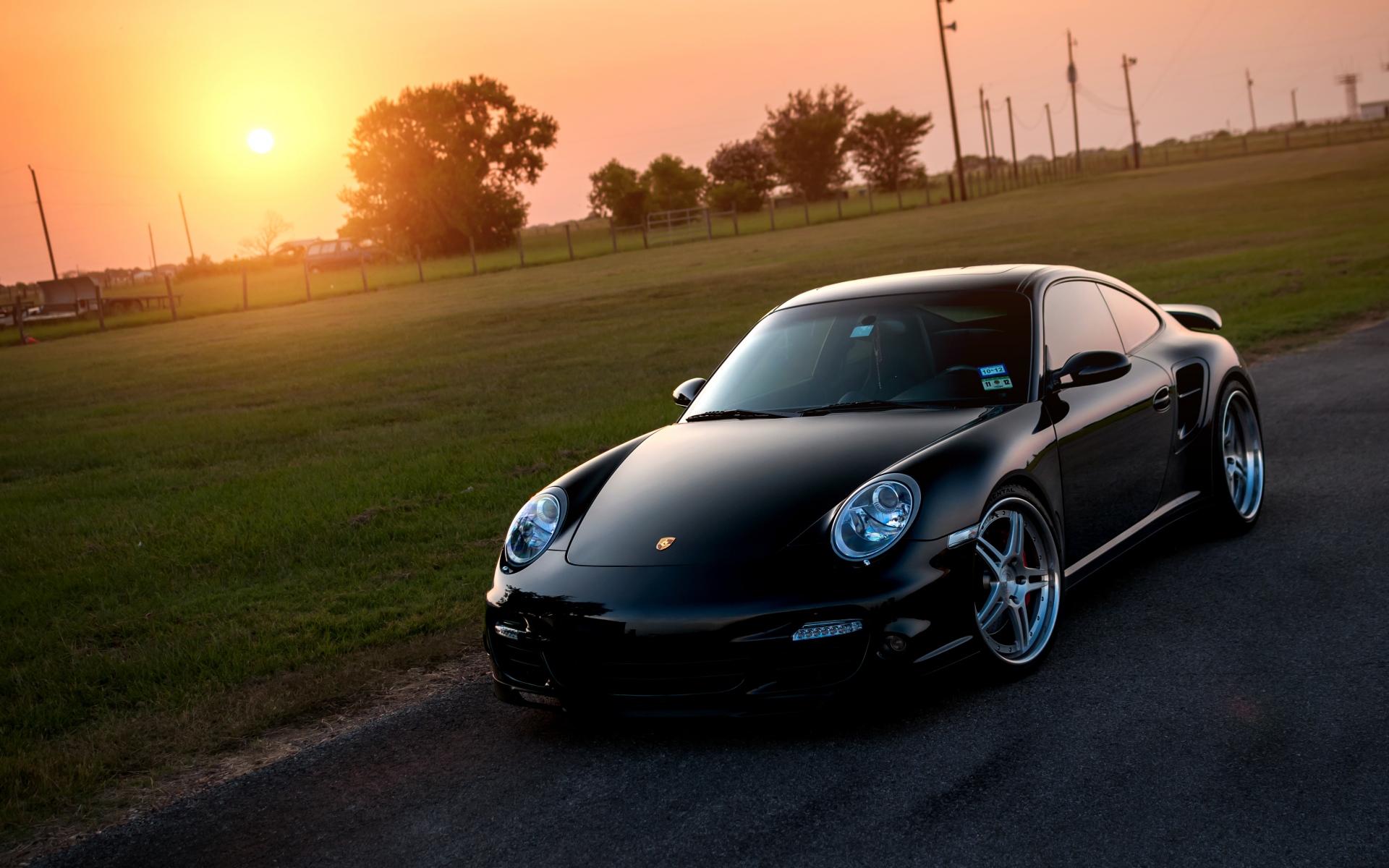 Картинки Porsche, 911, турбо, 997, черная, спереди, солнце, трава, размышления фото и обои на рабочий стол