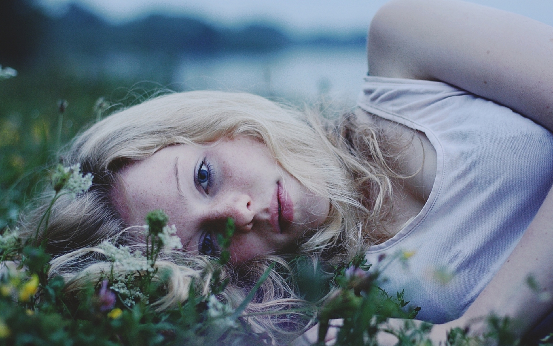 Девушка блондинка лежит на траве