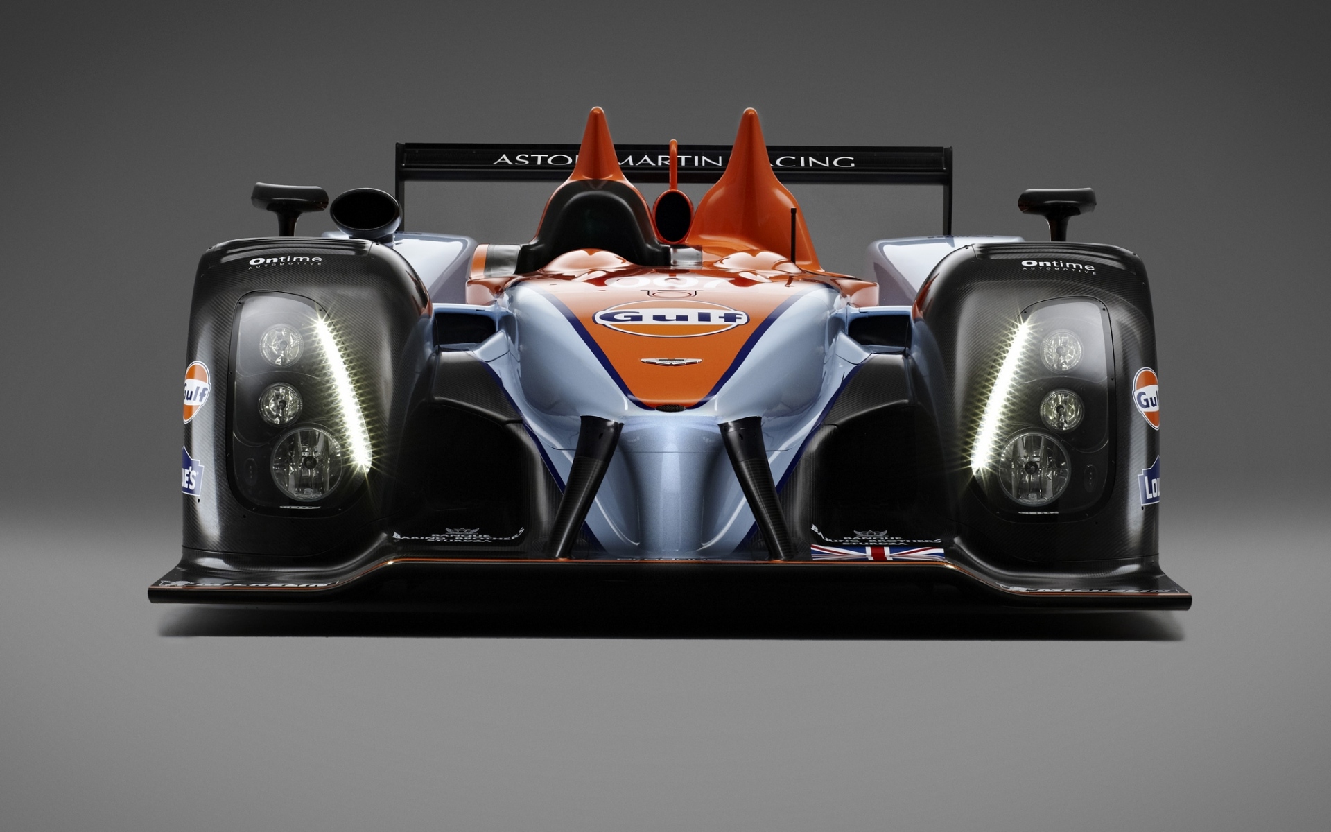 Картинки Aston martin, amr-one, lmp1, 2011, черный, оранжевый, вид спереди, гоночный автомобиль фото и обои на рабочий стол