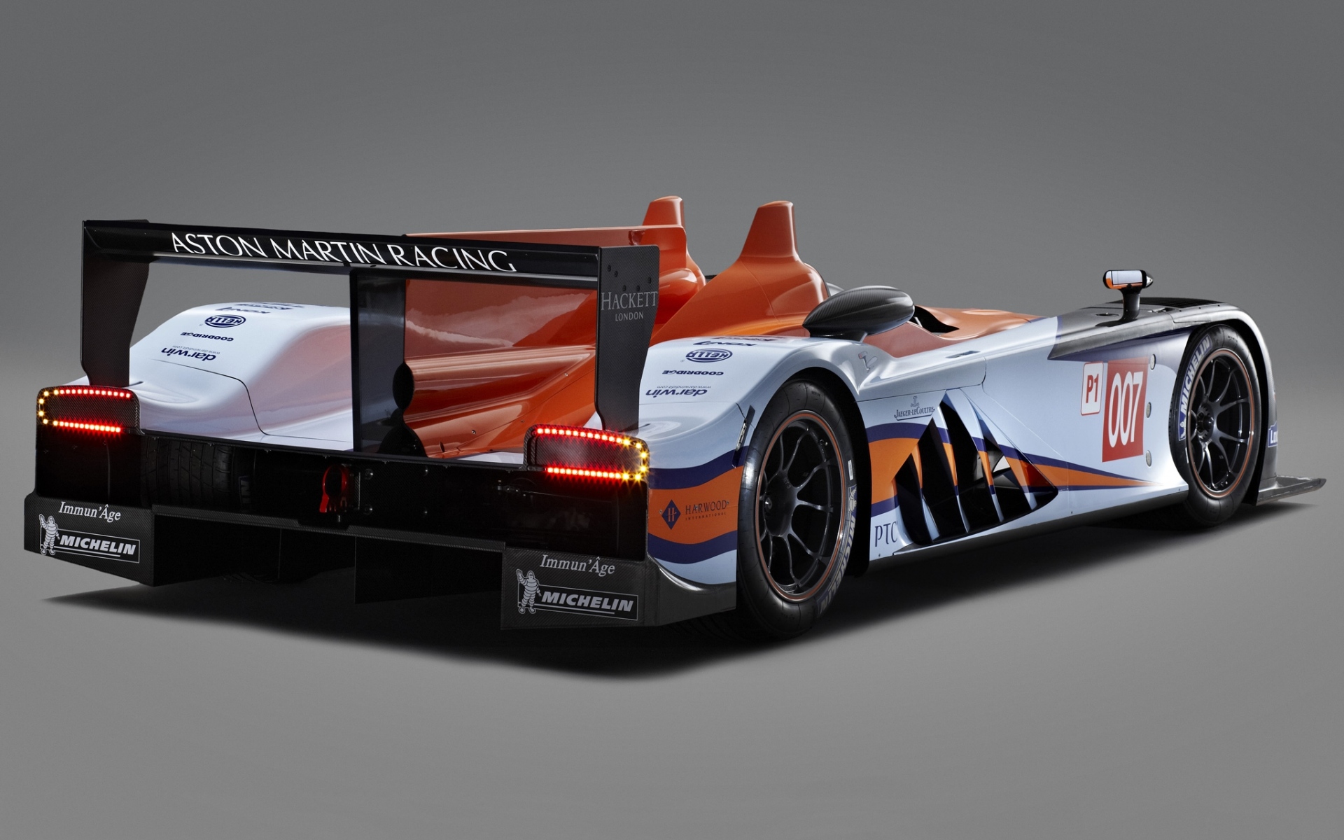 Картинки Aston martin, amr-one, lmp1, 2011, оранжевый, белый, вид сзади, спорт, авто фото и обои на рабочий стол