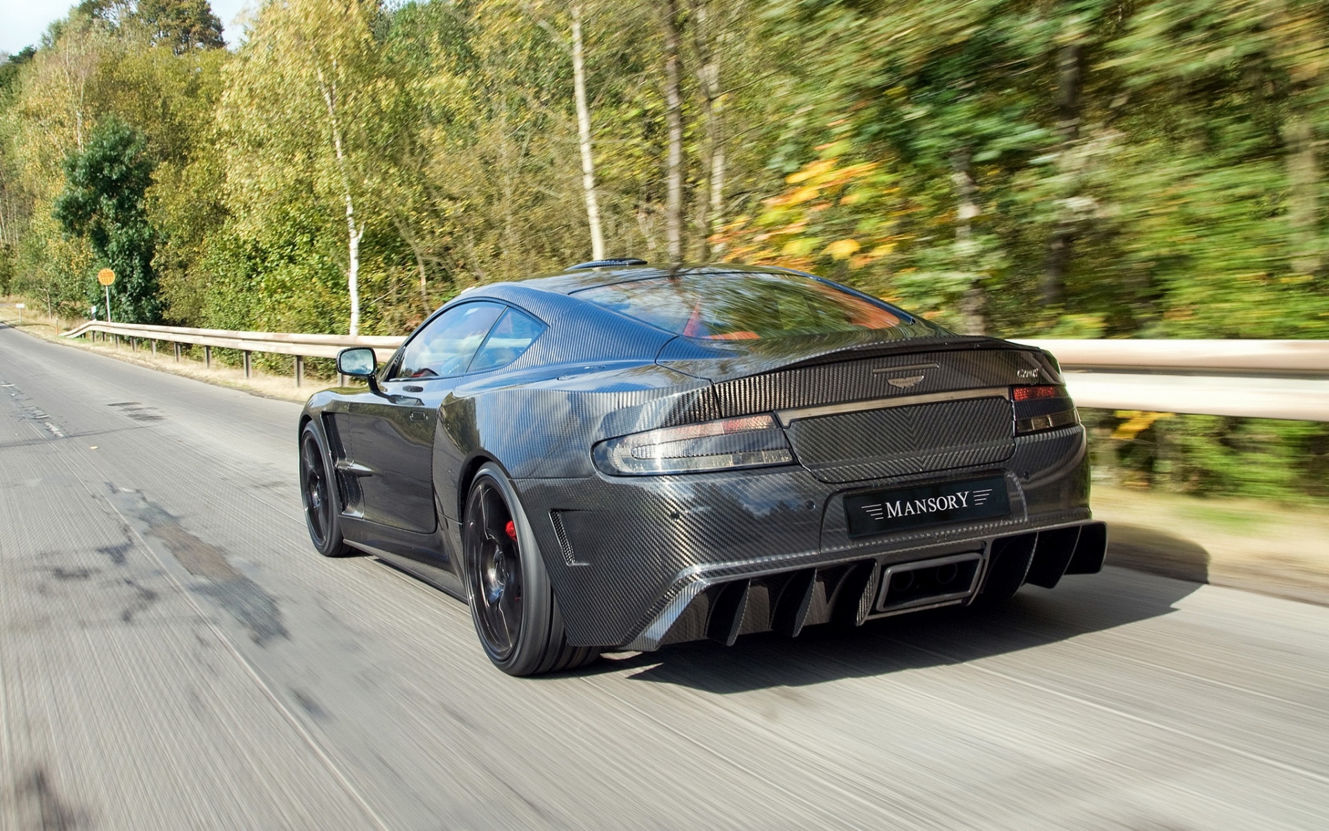 Картинки Mansory cyrus, 2009, черный, вид сзади, спорт, aston martin, деревья, скорость фото и обои на рабочий стол